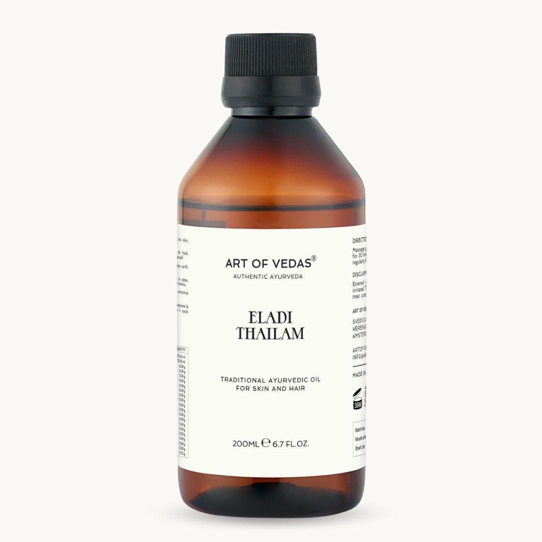 Bottle of Art of Vedas Eladi Thailam oil on a white background